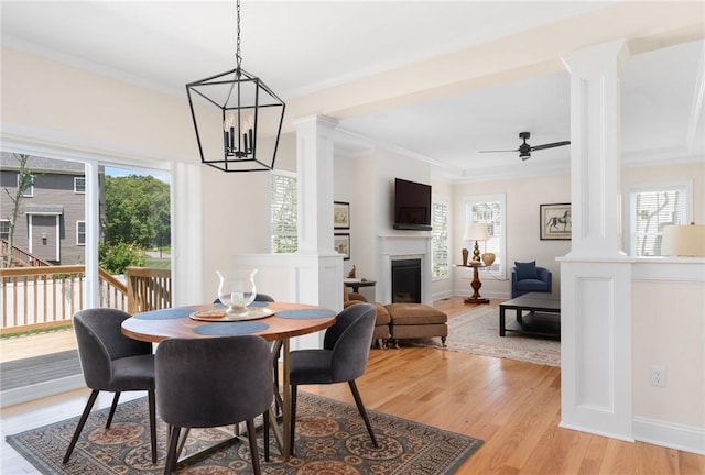 9 Scarlett Way, Cranston, RI 02921 - dining area featuring decorative columns, light wood-style floors, a fireplace, a chandelier, and a ceiling fan