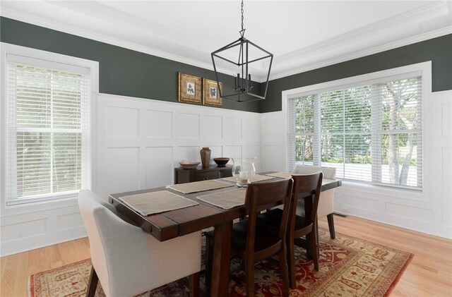 9 Scarlett Way, Cranston, RI 02921 - dining room with a decorative wall, a chandelier, crown molding, light wood finished floors, and a wainscoted wall