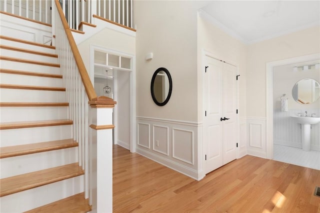 9 Scarlett Way, Cranston, RI 02921 - staircase with wood finished floors, wainscoting, and a decorative wall