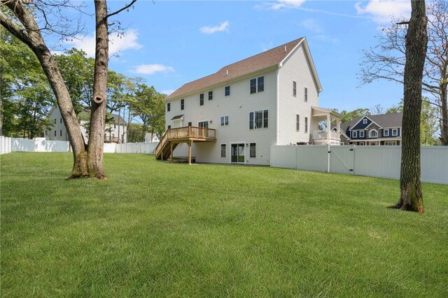 9 Scarlett Way, Cranston, RI 02921 - back of property featuring stairs, a fenced backyard, a wooden deck, and a gate