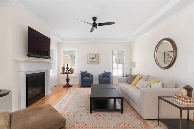 9 Scarlett Way, Cranston, RI 02921 - living area featuring ceiling fan, a glass covered fireplace, wood finished floors, ornamental molding, and a raised ceiling