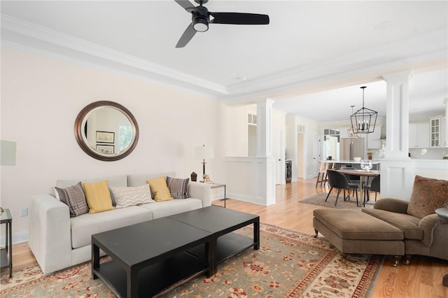9 Scarlett Way, Cranston, RI 02921 - living area with ornate columns, light wood-style flooring, crown molding, and a ceiling fan