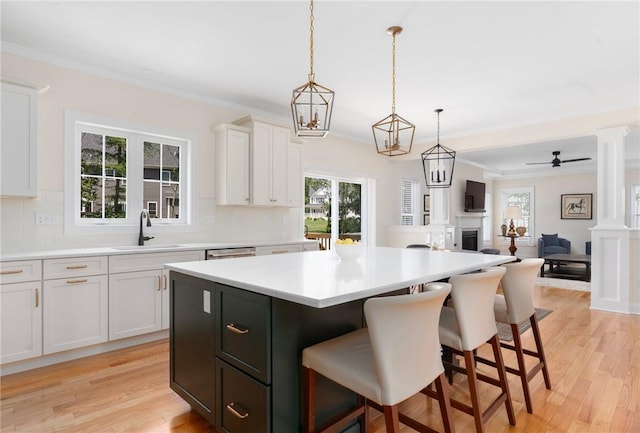 9 Scarlett Way, Cranston, RI 02921 - kitchen featuring backsplash, a kitchen island, a breakfast bar area, light countertops, and crown molding