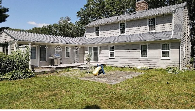 199 Love Ln, Warwick, RI 02886 - rear view of house featuring a chimney, a patio, and a lawn