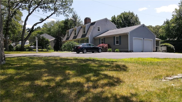 199 Love Ln, Warwick, RI 02886 - view of side of home featuring a garage, a lawn, a chimney, and a gambrel roof