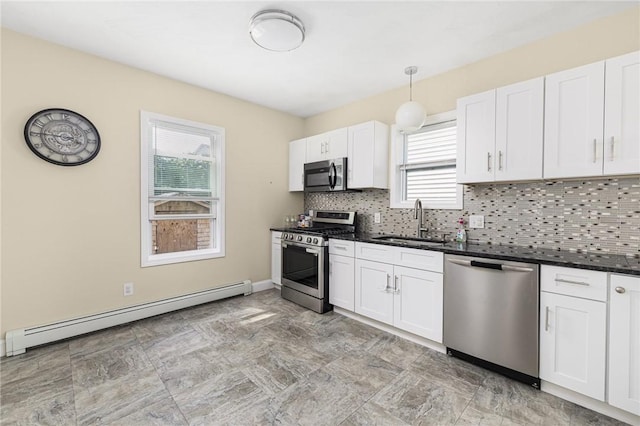 2 Palfrey Pl, Providence, RI 02909 - kitchen featuring appliances with stainless steel finishes, a baseboard heating unit, dark countertops, backsplash, and white cabinets
