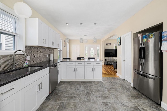 2 Palfrey Pl, Providence, RI 02909 - kitchen featuring stainless steel appliances, a peninsula, white cabinets, decorative backsplash, and dark stone countertops