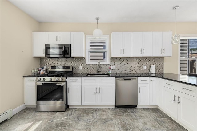 2 Palfrey Pl, Providence, RI 02909 - kitchen featuring appliances with stainless steel finishes, a baseboard heating unit, tasteful backsplash, and hanging light fixtures