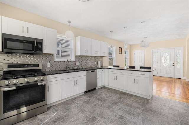 2 Palfrey Pl, Providence, RI 02909 - kitchen featuring stainless steel appliances, dark countertops, and white cabinetry