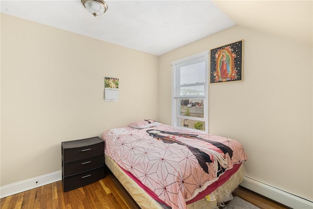 2 Palfrey Pl, Providence, RI 02909 - bedroom featuring a baseboard radiator, wood finished floors, and vaulted ceiling