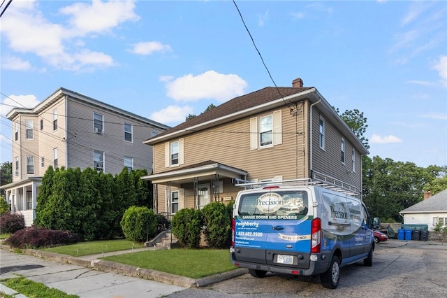 598 Laurel Hill Ave, Cranston, RI 02920 - view of front of home with a chimney and a front lawn