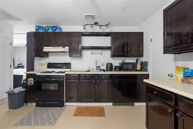 598 Laurel Hill Ave, Cranston, RI 02920 - kitchen with gas stove, under cabinet range hood, black microwave, and light countertops
