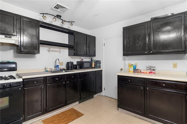 598 Laurel Hill Ave, Cranston, RI 02920 - kitchen featuring range with gas cooktop, black microwave, dark cabinetry, and light countertops