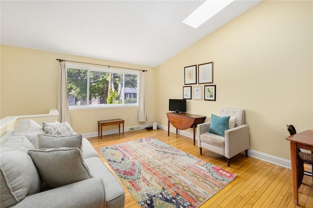 104 Conanicus Rd, Narragansett, RI 02882 - living room with vaulted ceiling, light wood finished floors, and a skylight