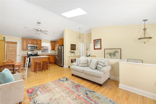 104 Conanicus Rd, Narragansett, RI 02882 - living area featuring vaulted ceiling, a skylight, light wood-style flooring, and ceiling fan