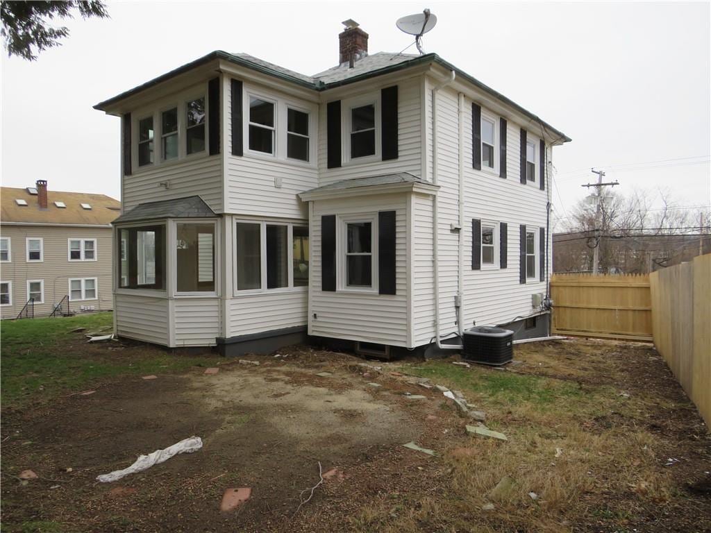690 Killingly St, Johnston, RI 02919 - back of property with a chimney and a sunroom