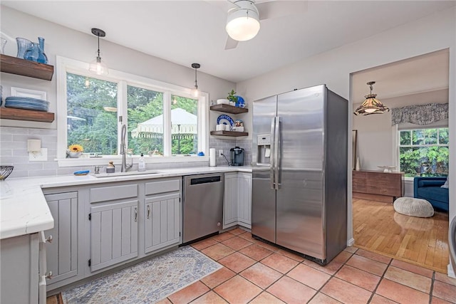 5 Havens Rd, Westerly, RI 02891 - kitchen with stainless steel appliances, open shelves, ceiling fan, backsplash, and decorative light fixtures