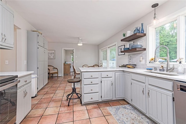 5 Havens Rd, Westerly, RI 02891 - kitchen featuring appliances with stainless steel finishes, a peninsula, light countertops, a ceiling fan, and open shelves