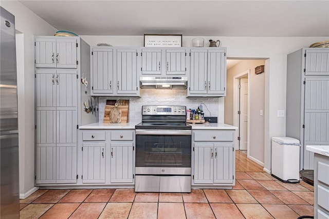 5 Havens Rd, Westerly, RI 02891 - kitchen featuring electric stove, under cabinet range hood, light countertops, tasteful backsplash, and light tile patterned floors