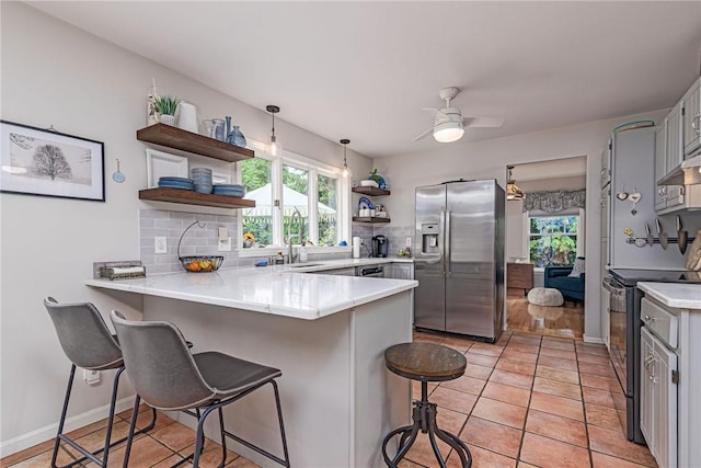 5 Havens Rd, Westerly, RI 02891 - kitchen with stainless steel appliances, open shelves, a peninsula, gray cabinets, and healthy amount of natural light