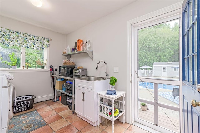 5 Havens Rd, Westerly, RI 02891 - kitchen featuring washing machine and dryer, plenty of natural light, white cabinetry, and open shelves