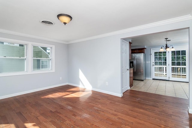 136 Davis Ave, Cranston, RI 02910 - spare room with light wood finished floors, crown molding, healthy amount of natural light, and a chandelier
