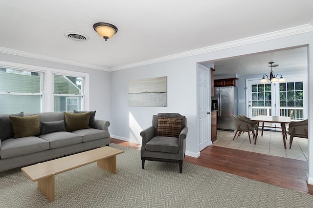 136 Davis Ave, Cranston, RI 02910 - living area featuring ornamental molding, healthy amount of natural light, a chandelier, and light wood finished floors