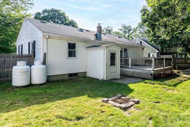 136 Davis Ave, Cranston, RI 02910 - rear view of house featuring a chimney, a deck, and an outdoor fire pit