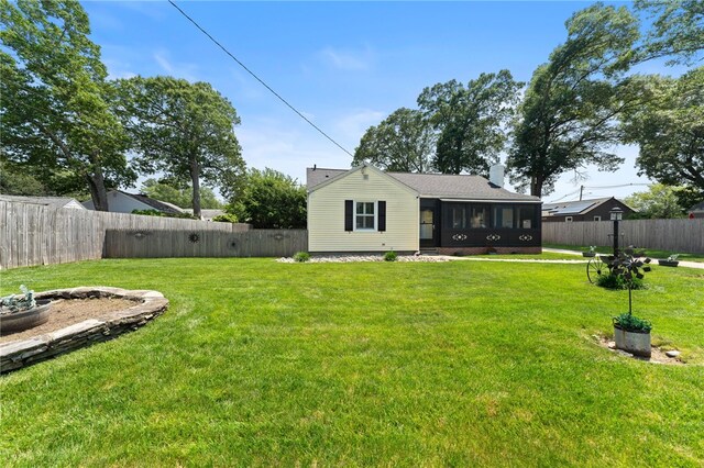 320 Miantonomo Dr, Warwick, RI 02888 - back of property featuring a sunroom and a fenced backyard