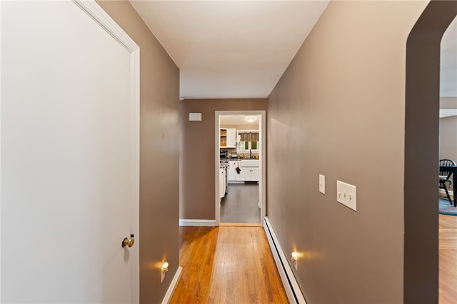 320 Miantonomo Dr, Warwick, RI 02888 - corridor featuring a baseboard radiator, light wood-type flooring, and arched walkways