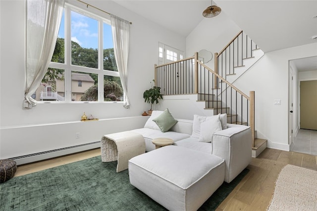 193 Mohawk Trl, Cranston, RI 02921 - living area featuring a baseboard radiator, wood finished floors, and stairs