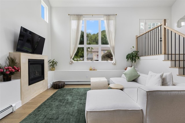 193 Mohawk Trl, Cranston, RI 02921 - living room featuring wood finished floors, a fireplace, a baseboard radiator, and stairway