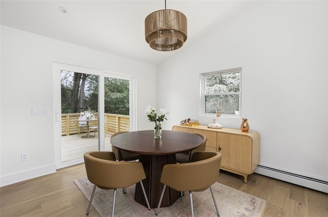 193 Mohawk Trl, Cranston, RI 02921 - dining area featuring light wood finished floors, healthy amount of natural light, a baseboard radiator, and lofted ceiling