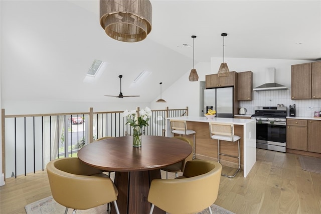 193 Mohawk Trl, Cranston, RI 02921 - dining room featuring lofted ceiling, light wood finished floors, and a ceiling fan