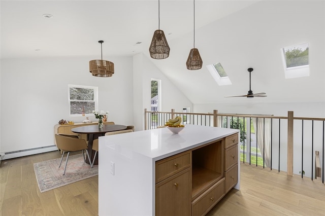 193 Mohawk Trl, Cranston, RI 02921 - kitchen featuring a skylight, vaulted ceiling, a baseboard heating unit, a ceiling fan, and light wood-type flooring