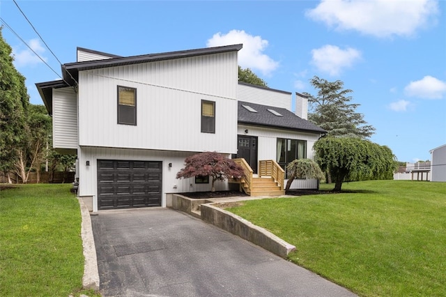 193 Mohawk Trl, Cranston, RI 02921 - tri-level home featuring a garage, a front lawn, and asphalt driveway