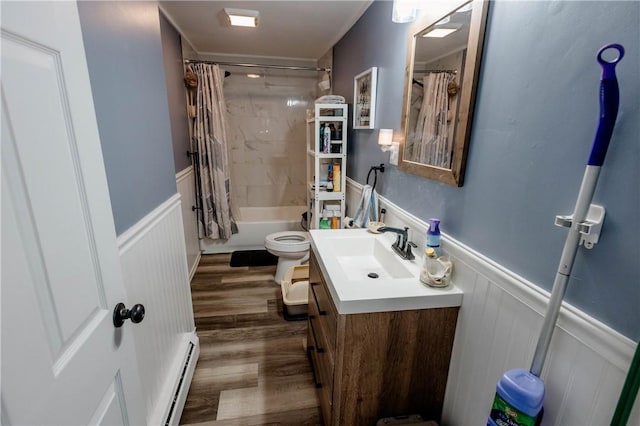 25 Unit St, Providence, RI 02909 - full bath featuring a baseboard radiator, wainscoting, vanity, wood finished floors, and shower / tub combo