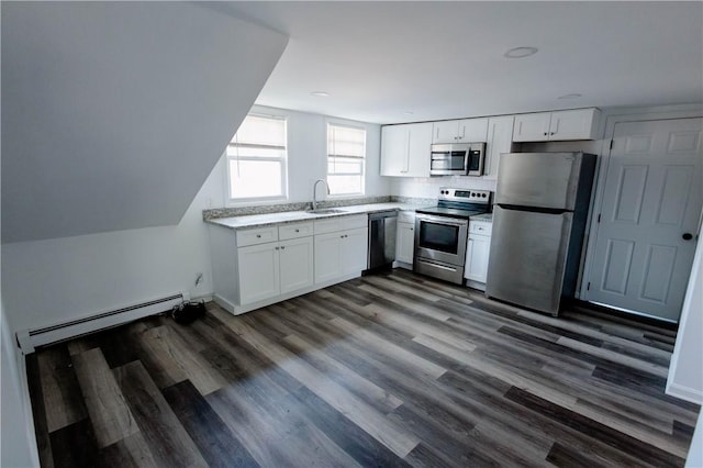 25 Unit St, Providence, RI 02909 - kitchen featuring appliances with stainless steel finishes, a baseboard heating unit, white cabinetry, dark wood-style floors, and light stone counters