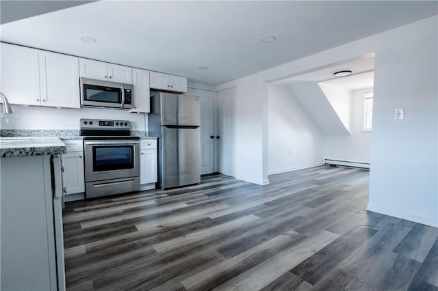25 Unit St, Providence, RI 02909 - kitchen with stainless steel appliances, a baseboard heating unit, white cabinets, decorative backsplash, and dark wood-style flooring