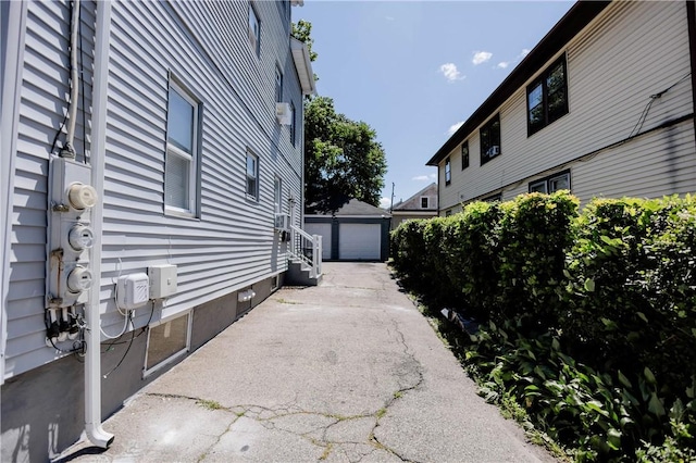 25 Unit St, Providence, RI 02909 - view of home's exterior with an outdoor structure and a detached garage