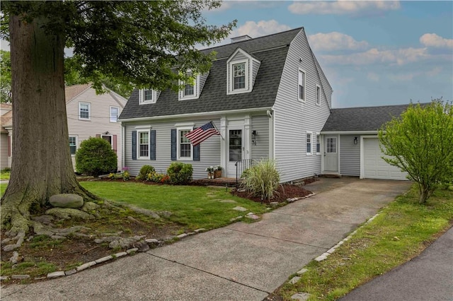31 Bowen St, East Providence, RI 02916 - dutch colonial featuring a shingled roof, an attached garage, driveway, and a front lawn