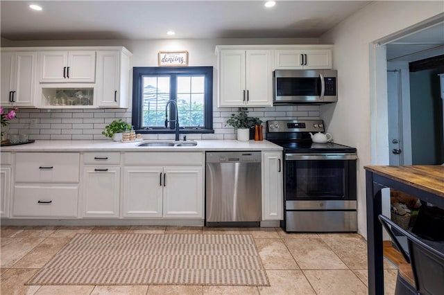 31 Bowen St, East Providence, RI 02916 - kitchen featuring stainless steel appliances, light countertops, decorative backsplash, white cabinets, and recessed lighting
