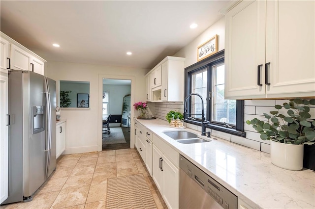 31 Bowen St, East Providence, RI 02916 - kitchen with appliances with stainless steel finishes, tasteful backsplash, white cabinetry, recessed lighting, and light stone countertops