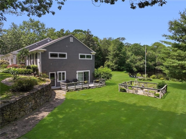469 Fletcher Rd, North Kingstown, RI 02852 - back of house featuring a lawn, a garden, and a deck