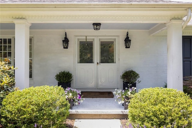 469 Fletcher Rd, North Kingstown, RI 02852 - entrance to property featuring brick siding, covered porch, and french doors