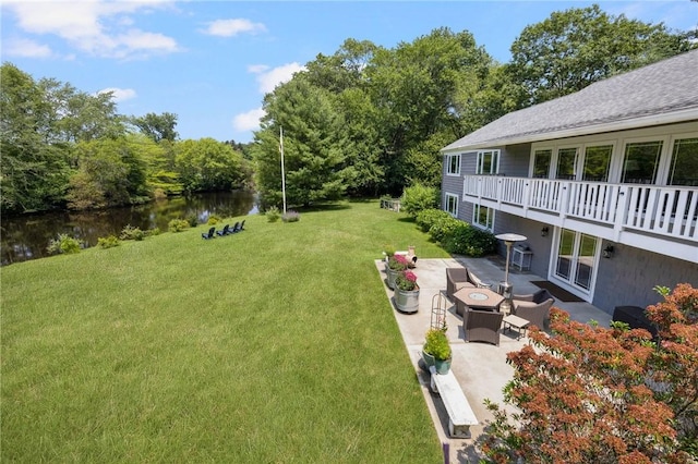 469 Fletcher Rd, North Kingstown, RI 02852 - view of grassy yard with a water view, a patio area, and an outdoor fire pit