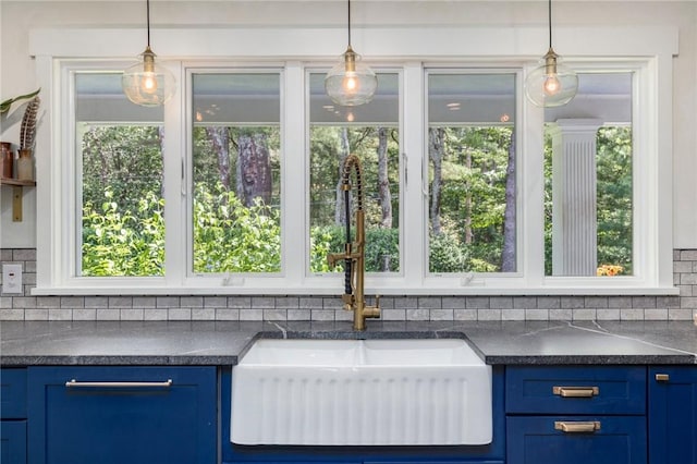 469 Fletcher Rd, North Kingstown, RI 02852 - kitchen with dark countertops, blue cabinets, and tasteful backsplash