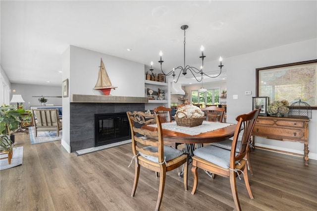 469 Fletcher Rd, North Kingstown, RI 02852 - dining space with wood finished floors, a chandelier, a tile fireplace, and recessed lighting