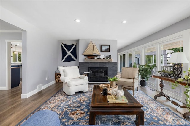 469 Fletcher Rd, North Kingstown, RI 02852 - living room featuring a glass covered fireplace, recessed lighting, and wood finished floors