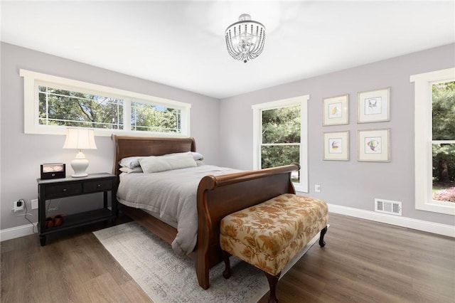 469 Fletcher Rd, North Kingstown, RI 02852 - bedroom with dark wood-type flooring and a chandelier